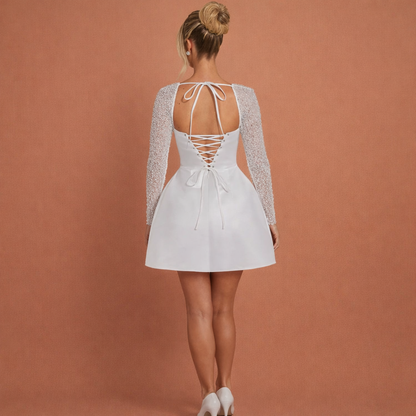 Elegant mini dress with a shiny appearance and long sleeves for women | Nina
